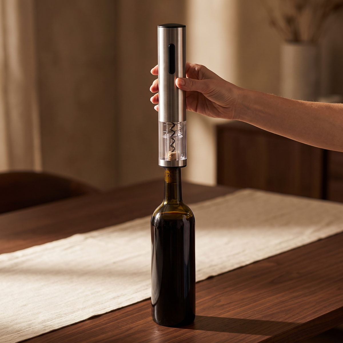 Ouverture d'une bouteille de vin avec le tire-bouchon électrique du Sommelier